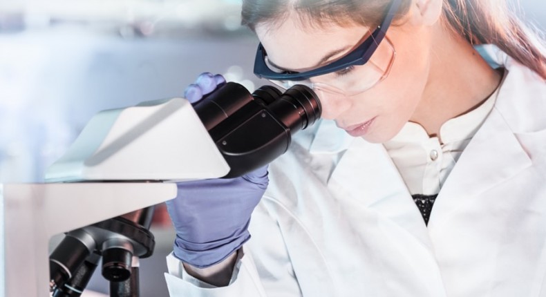 500px Photo ID: 215230985 - Life scientists researching in laboratory. Attractive female young scientist microscoping in their working environment. Healthcare and biotechnology.